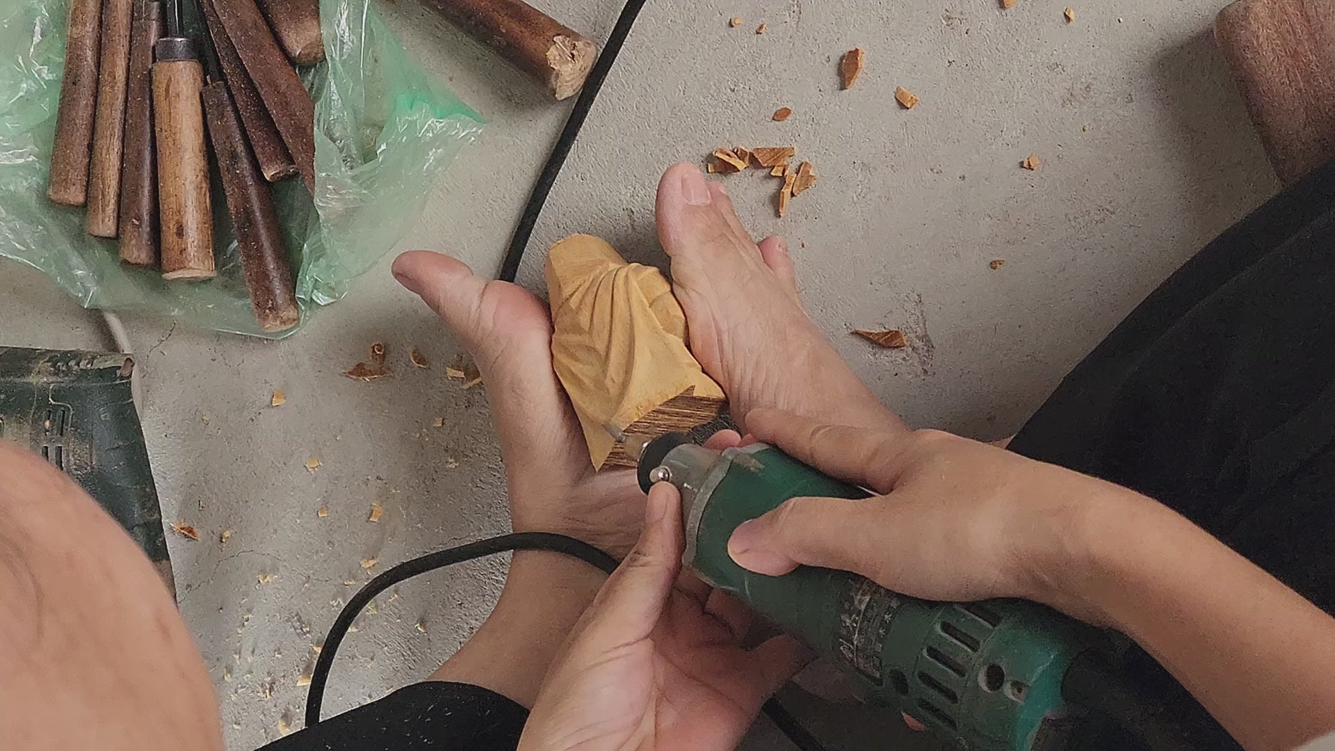 Close-up video of artisan hands using a rotary tool to carve intricate fur details on a wooden Highland Cow figurine (Hamish). Handcrafted woodworking process at BeeRusty